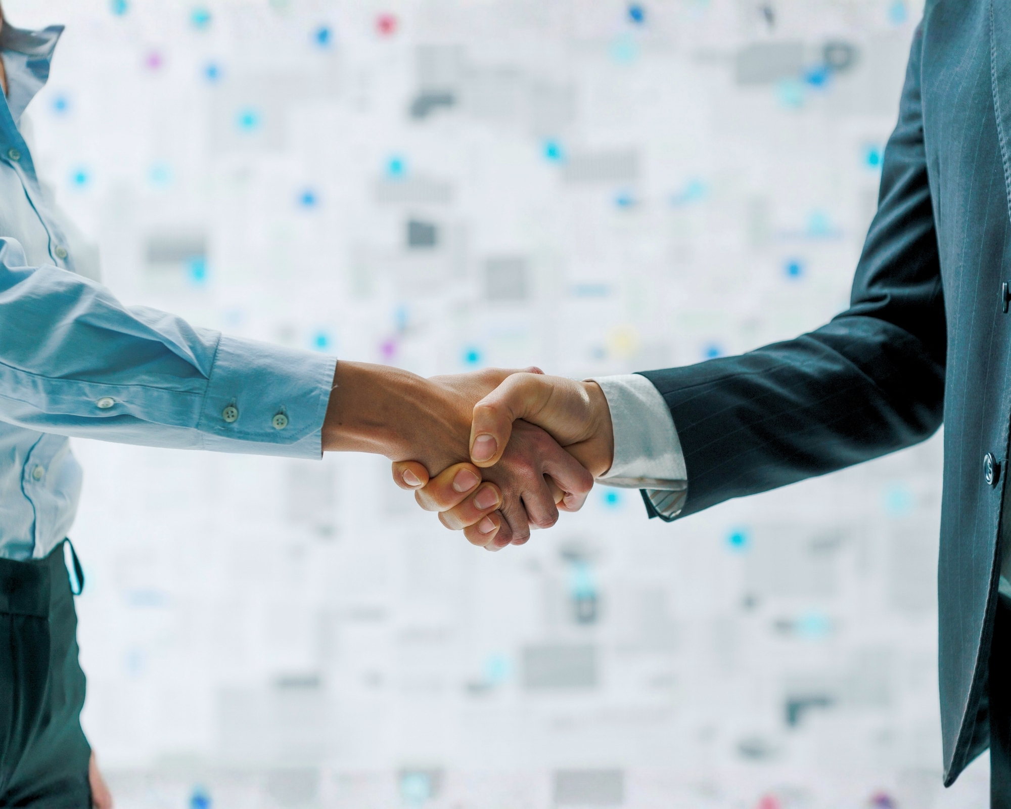 Two corporate professionals shaking hands, symbolising a mutually beneficial business collaboration with IberianTax